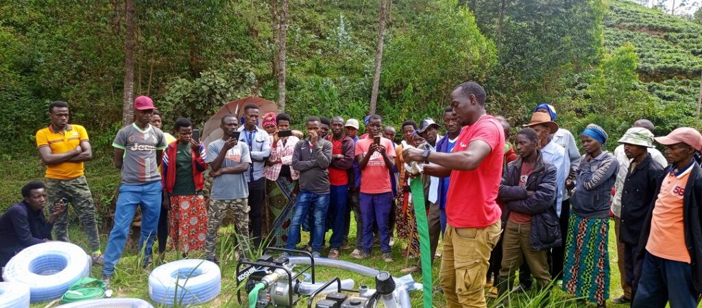 Training on how to connect well irrigation pump before being used.The trainer is project staff